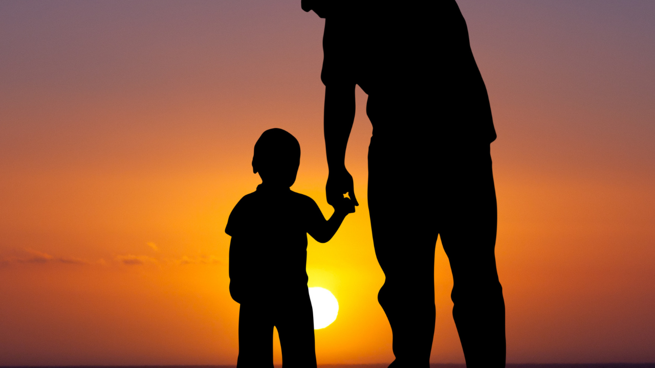 Father and son watch the sunset