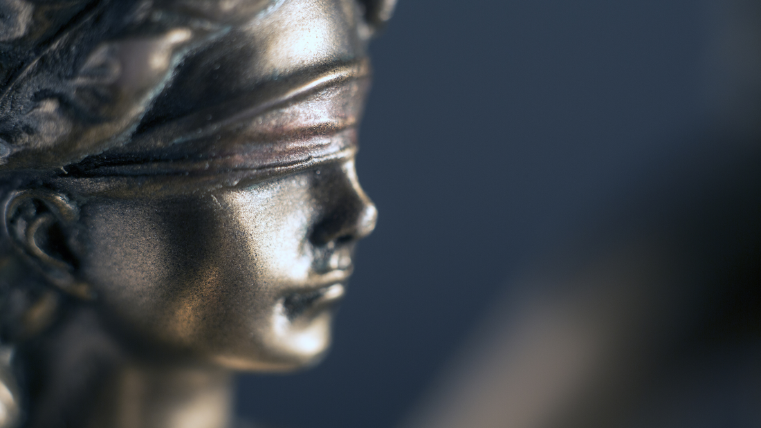 A close up of Lady Justice wearing a blindfold.